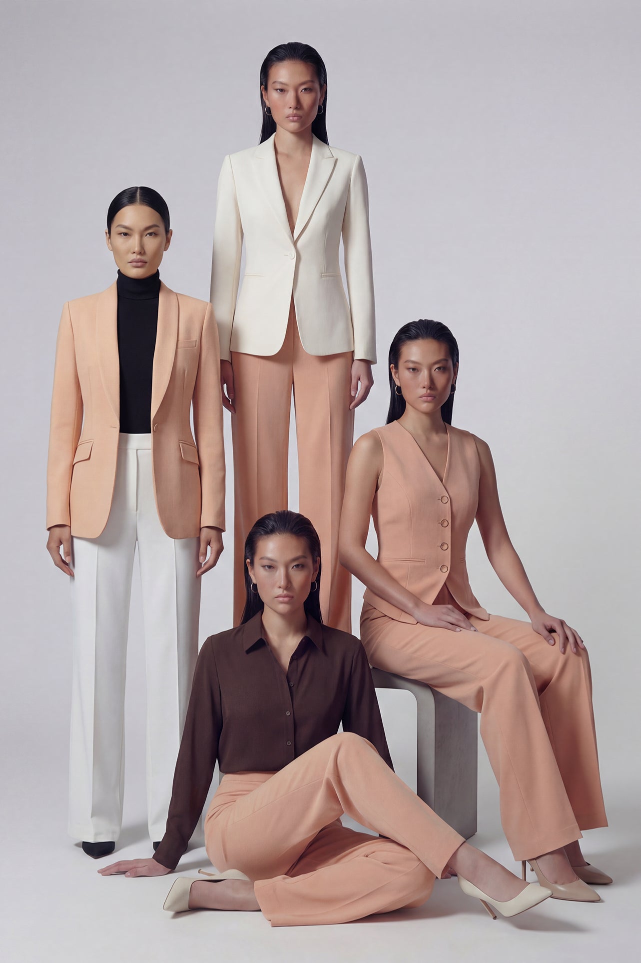 A professional woman wearing sophisticated apricot-colored high-waisted straight-leg trousers, featuring a unique pointed waistband design for a tailored executive office look.