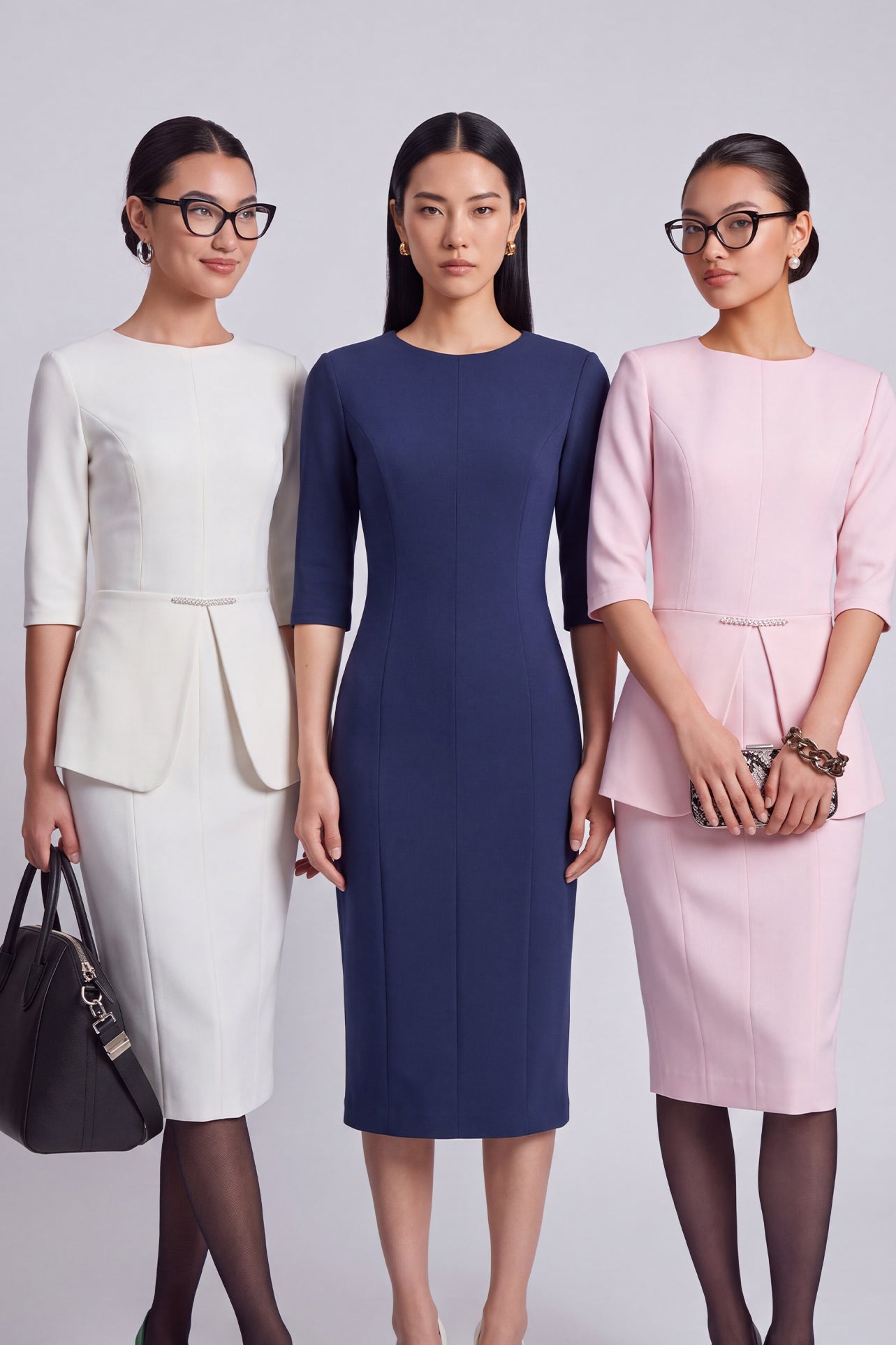 A style comparison of three elegant women modeling tailored three-quarter sleeve crew-neck pencil midi dresses; featured in ivory white and blush pink with a subtle peplum waist and crystal bar detail, and in navy blue with a clean minimalist sheath silhouette.