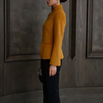 A chic professional Asian woman wearing a luxurious camel wool tailored jacket featuring a sleek stand collar, exposed two-way front zipper, structured shoulders, and an hourglass silhouette paired with a matching skirt.
