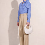 A style comparison of two elegant tailored two-piece suit sets featuring longline sleeveless blazer vests with notched lapels and matching cuffed wide-leg trousers; the left shown in slate blue and the right in sophisticated oatmeal beige.
