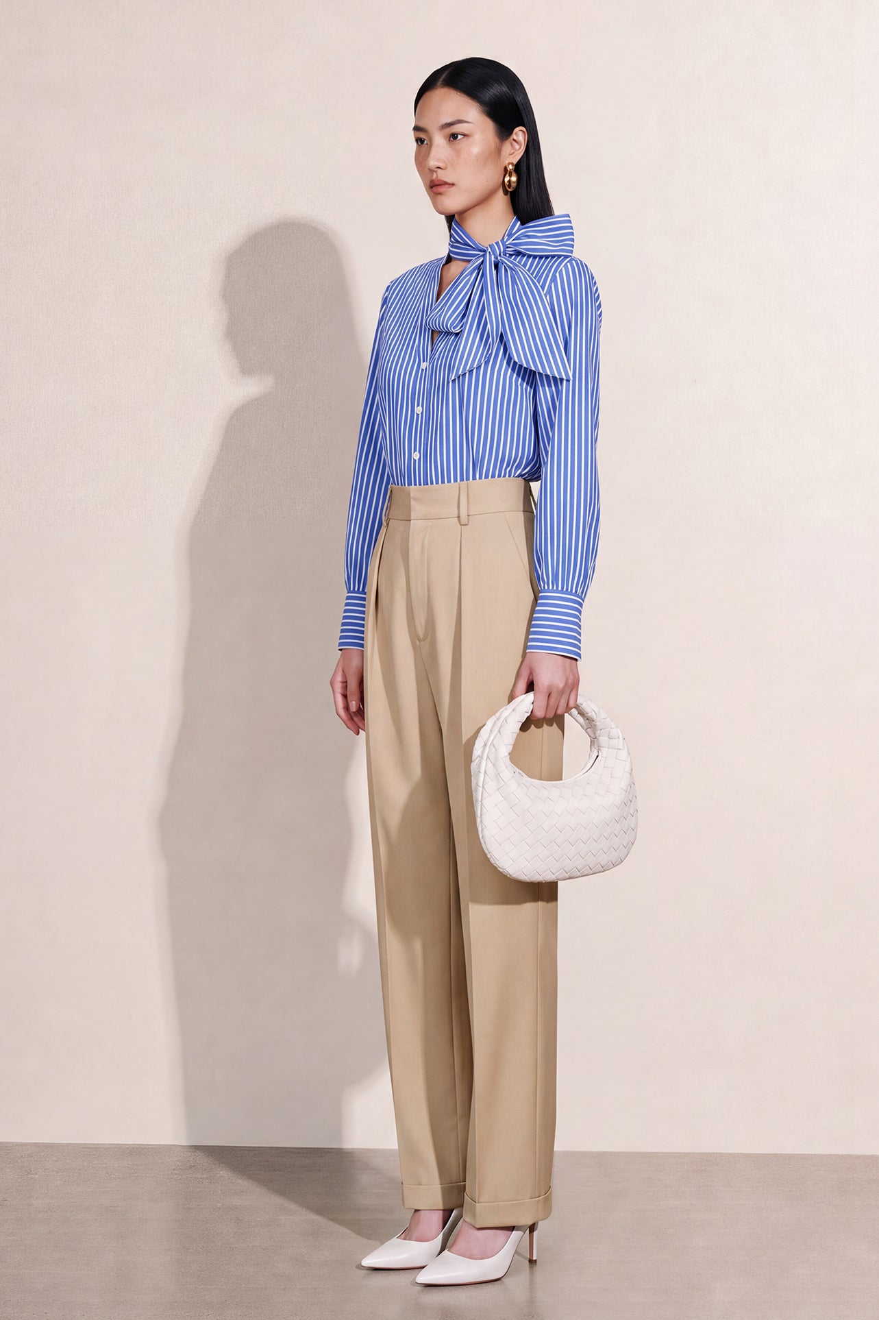 A style comparison of two elegant tailored two-piece suit sets featuring longline sleeveless blazer vests with notched lapels and matching cuffed wide-leg trousers; the left shown in slate blue and the right in sophisticated oatmeal beige.