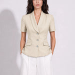 A style comparison of two professional summer short-sleeve blazers featuring an elegant shawl collar, three-button front, and flap pockets; the left shown in vibrant royal blue and the right in sophisticated light beige.