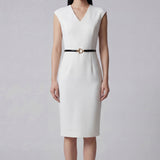 A professional woman wearing a sophisticated solid white sleeveless sheath dress, featuring a flattering V-neckline and an elegant thin black belt with a gold buckle for a polished executive office look.
