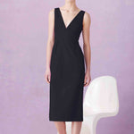 A professional woman showcasing two elegant sleeveless V-neck sheath dresses in classic black and soft lilac purple, featuring functional side pockets and a tailored fit for a polished office look.