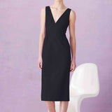 A professional woman showcasing two elegant sleeveless V-neck sheath dresses in classic black and soft lilac purple, featuring functional side pockets and a tailored fit for a polished office look.