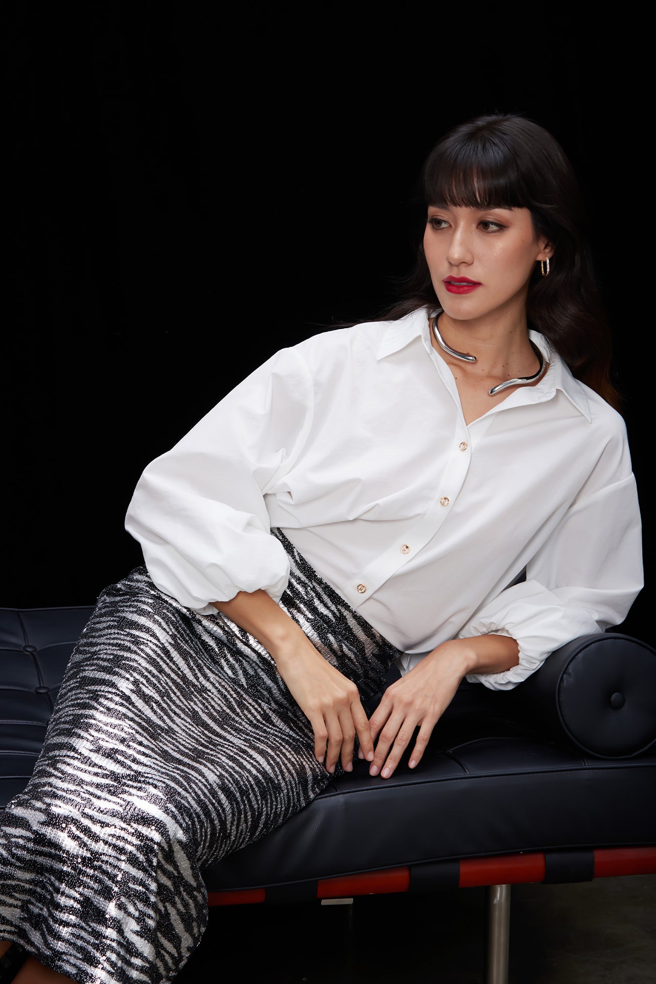A woman wearing a glamorous high-waisted pencil skirt featuring shimmering silver and black sequins in a stylish zebra print, ideal for an elegant evening party or a night out.
