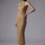 A stunning professional model wearing a luxurious gold sequined halter neck evening gown, featuring a sophisticated keyhole neckline and a slim-fit silhouette for a formal gala look.