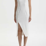 Model wearing a minimalist sleeveless modern Qipao dress featuring a mandarin collar, asymmetric side buttons, and a high thigh slit.