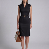 A professional woman wearing a sophisticated beige sleeveless sheath dress, featuring an elegant mandarin collar with a V-neckline and a slim black belt for a polished executive office look.
