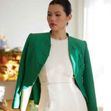 A professional woman wearing a stunning vibrant green blazer, featuring a traditional mandarin collar and elegant frog button detailing for a modern oriental-inspired executive look.