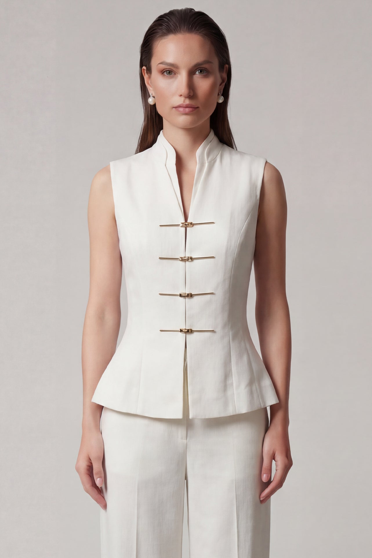 A professional woman modeling stylish high-waisted wide-leg trousers in a classic black pinstripe pattern, featuring sophisticated front pleats and a flattering long-line silhouette for an elegant office look.