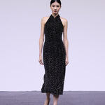 A stunning woman wearing a sophisticated black sequin halter midi dress, featuring a traditional mandarin collar and a shimmering bodycon silhouette, perfect for a modern oriental-inspired evening party look.