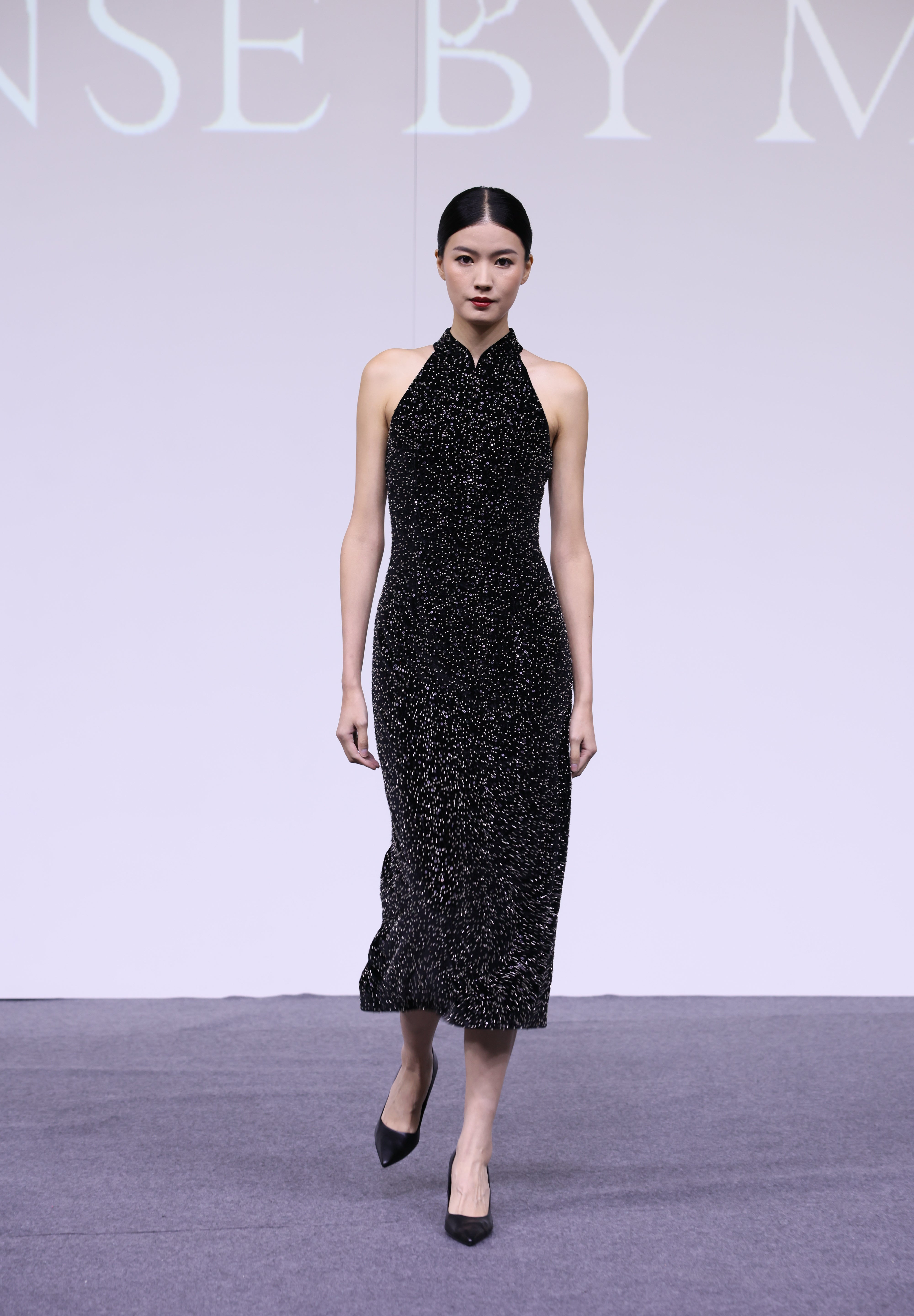 A stunning woman wearing a sophisticated black sequin halter midi dress, featuring a traditional mandarin collar and a shimmering bodycon silhouette, perfect for a modern oriental-inspired evening party look.