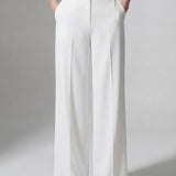 A professional woman wearing sophisticated black high-waisted wide-leg trousers, featuring a flattering high-rise fit and a flowing full-length silhouette for an elegant office look.