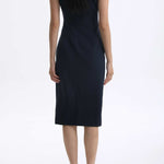 A professional woman wearing a sophisticated navy blue midi dress, featuring an elegant pleated neckline with a subtle keyhole detail and a tailored slim-fit pencil silhouette for a polished executive look.