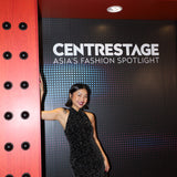 A stunning woman wearing a sophisticated black sequin halter midi dress, featuring a traditional mandarin collar and a shimmering bodycon silhouette, perfect for a modern oriental-inspired evening party look.
