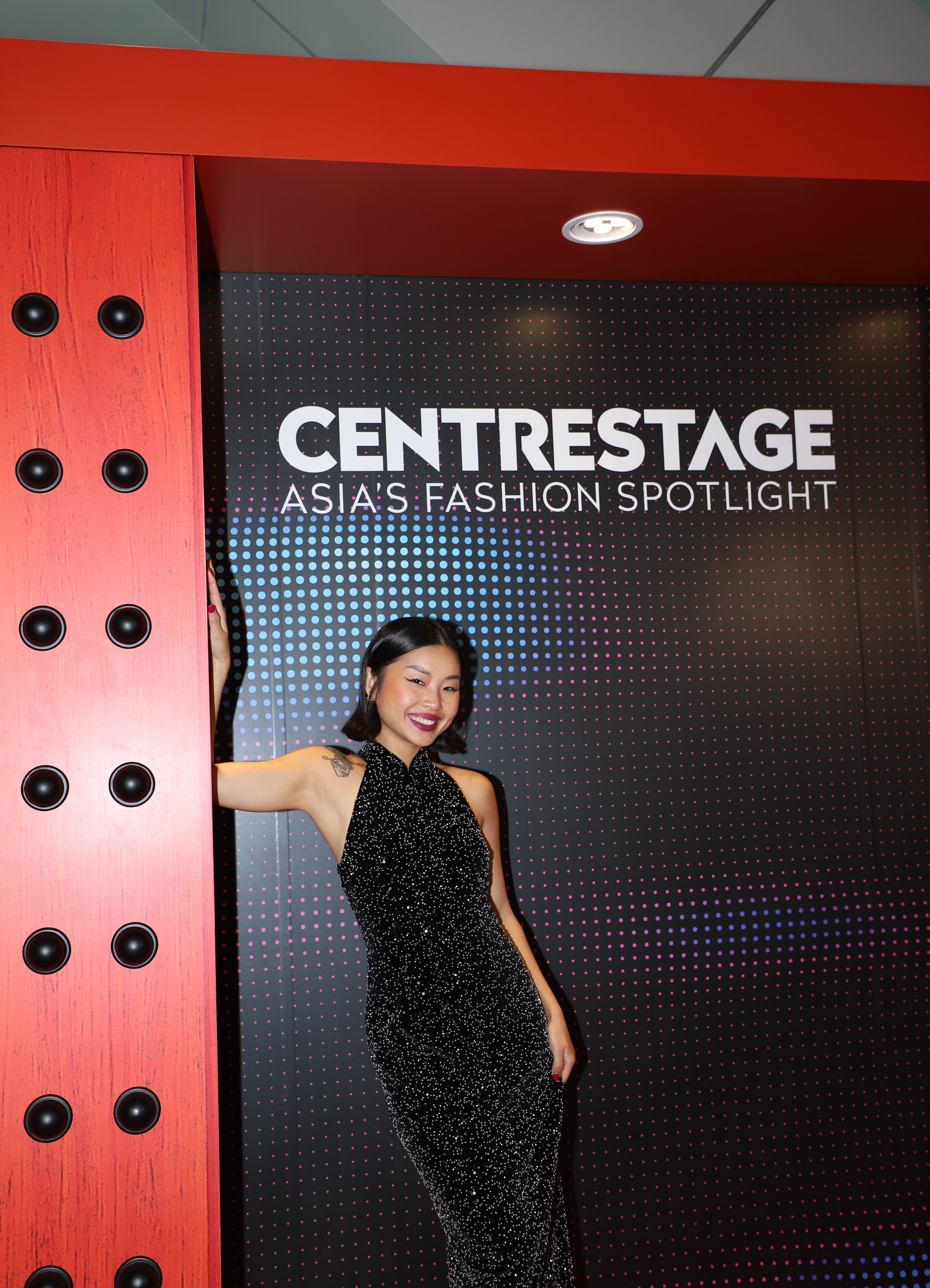 A stunning woman wearing a sophisticated black sequin halter midi dress, featuring a traditional mandarin collar and a shimmering bodycon silhouette, perfect for a modern oriental-inspired evening party look.