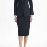 A professional woman wearing a sophisticated black belted blazer dress, featuring a tailored slim-fit silhouette with a waist-defining belt for a powerful executive business look.