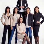 A professional woman wearing a sophisticated black skirt suit, featuring a mandarin collar with elegant leaf embroidery on the shoulder and skirt, and traditional frog button detailing for a modern oriental executive look.