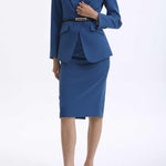 A professional woman wearing a sophisticated royal blue tailored skirt suit, featuring a slim-fit single-button blazer with structured shoulders and a matching midi pencil skirt for a powerful executive office look.