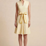 A side-by-side comparison of an elegant pale yellow sleeveless dress in two lengths, featuring a sophisticated mandarin collar, a stylish bow tie-waist, and a pleated A-line skirt for a classic feminine look