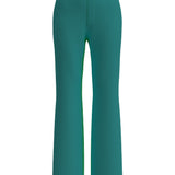 A professional woman wearing sophisticated emerald green high-waisted flare trousers, featuring a tailored slim fit through the hip and a stylish bootcut silhouette for an elegant office look.