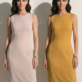 A professional woman modeling an elegant mustard yellow sleeveless sheath dress, featuring a sophisticated crew neckline and a tailored slim fit with princess seams for a polished executive look.