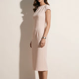 A professional woman modeling an elegant pale pink sheath dress, featuring a sophisticated crew neckline, cap sleeves, and a tailored slim fit with princess seams for a timeless executive look.