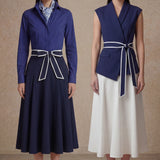 A comparison of two elegant professional looks: a navy blue pleated midi skirt and a crisp white flare skirt, both featuring sophisticated contrast-piped bow belts for a polished executive appearance.