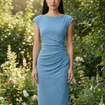 Two professional women modeling elegant sky blue and light grey sheath dresses, featuring a sophisticated boat neck, cap sleeves, and slimming side ruched details for a polished executive look