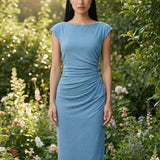 Two professional women modeling elegant sky blue and light grey sheath dresses, featuring a sophisticated boat neck, cap sleeves, and slimming side ruched details for a polished executive look