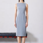 A professional woman wearing a sophisticated light grey pinstripe sleeveless sheath dress, featuring an elegant boat neckline and a tailored slim-fit silhouette for a polished executive look.