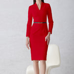 A professional woman wearing a sophisticated solid white long-sleeve sheath dress, featuring an elegant V-neckline and a slim black belt with a gold buckle for a polished executive office look.