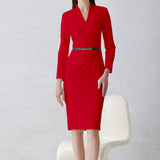 A professional woman wearing a sophisticated solid white long-sleeve sheath dress, featuring an elegant V-neckline and a slim black belt with a gold buckle for a polished executive office look.