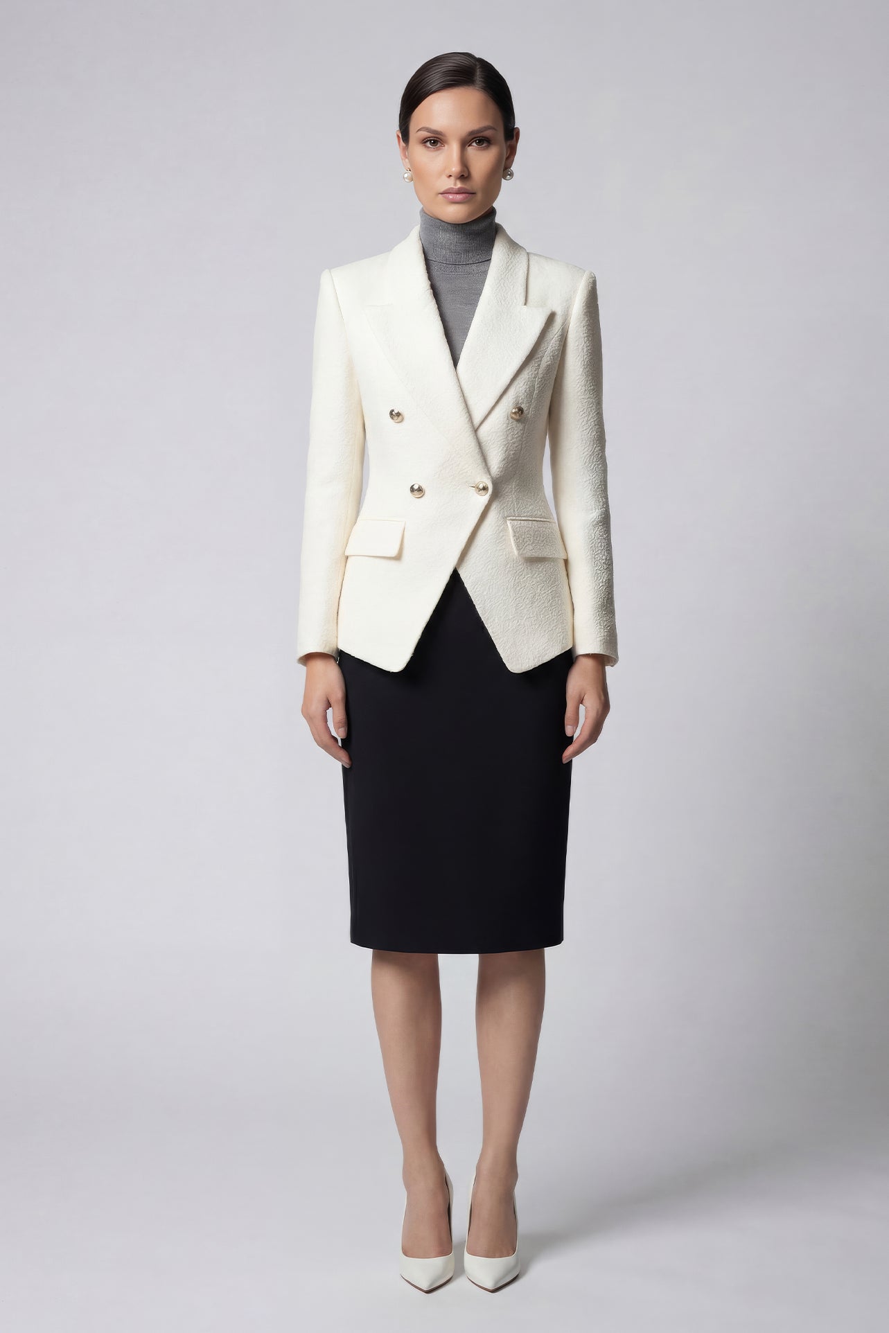A professional woman wearing a sophisticated cream white double-breasted tweed blazer, featuring elegant gold buttons, a tailored slim fit, and classic flap pockets for a polished executive look.