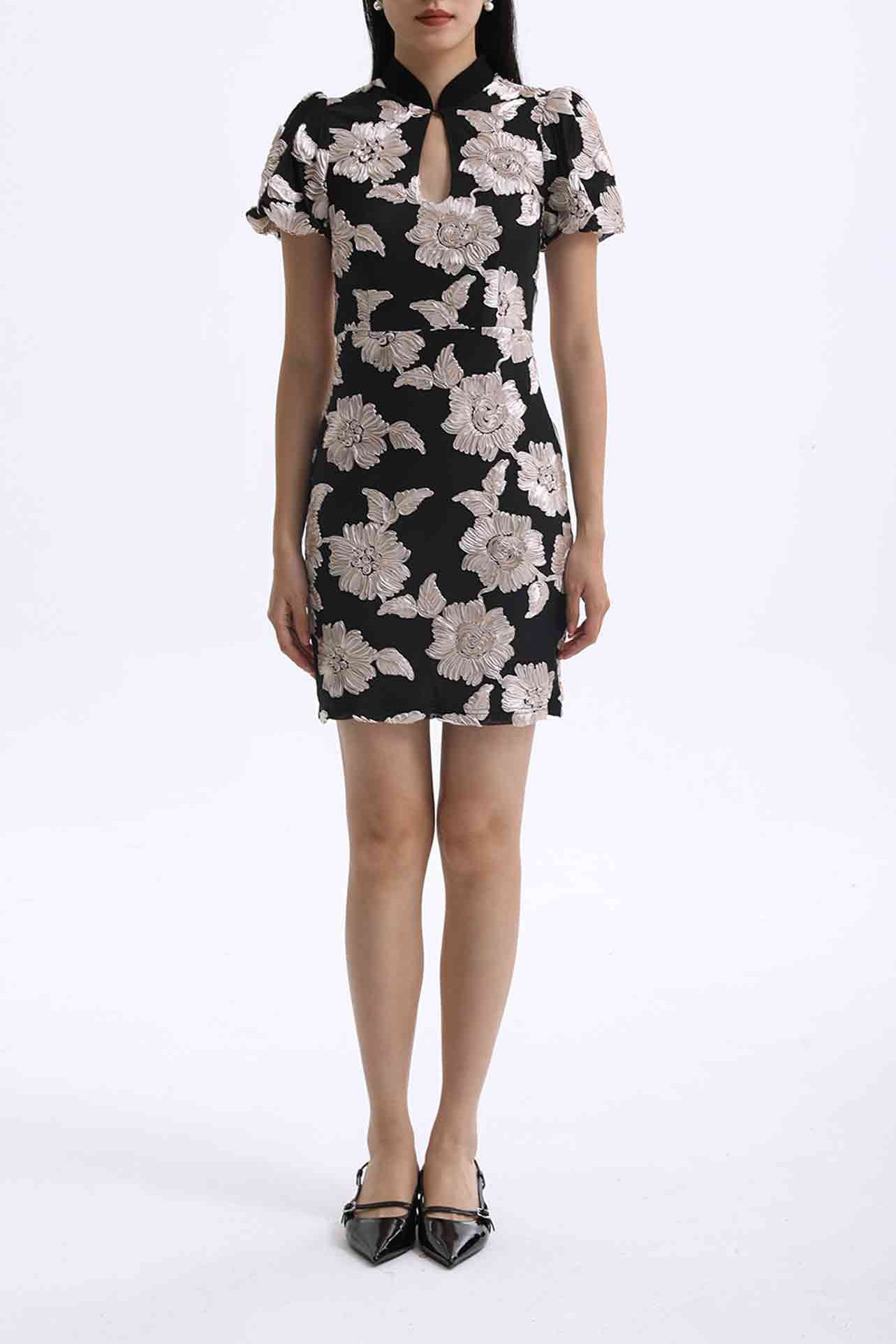 A professional woman wearing a modern black mini qipao dress, featuring elegant white floral embroidery, voluminous puff sleeves, and a chic keyhole neckline with a mandarin collar for a stylish party look.