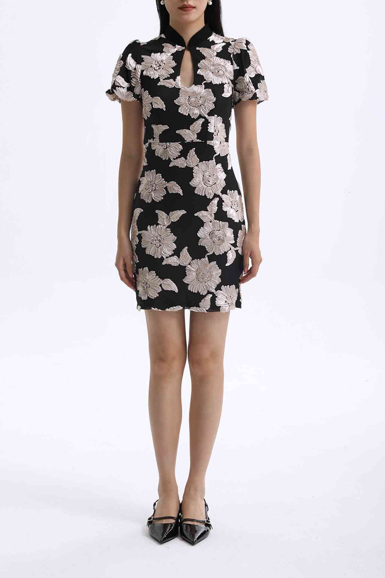 A professional woman wearing a modern black mini qipao dress, featuring elegant white floral embroidery, voluminous puff sleeves, and a chic keyhole neckline with a mandarin collar for a stylish party look.