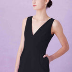 A professional woman showcasing two elegant sleeveless V-neck sheath dresses in classic black and soft lilac purple, featuring functional side pockets and a tailored fit for a polished office look.