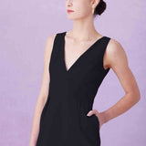A professional woman showcasing two elegant sleeveless V-neck sheath dresses in classic black and soft lilac purple, featuring functional side pockets and a tailored fit for a polished office look.