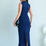 A professional woman wearing a sophisticated navy blue sleeveless midi dress, featuring an elegant high neckline and flattering ruched detailing along the side for a slim-fit executive look.