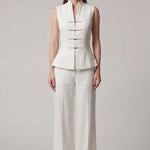 A professional woman modeling stylish high-waisted wide-leg trousers in a classic black pinstripe pattern, featuring sophisticated front pleats and a flattering long-line silhouette for an elegant office look.