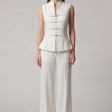 A professional woman modeling stylish high-waisted wide-leg trousers in a classic black pinstripe pattern, featuring sophisticated front pleats and a flattering long-line silhouette for an elegant office look.