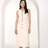 A professional woman wearing a sophisticated off-white pinstripe vest top, featuring a slim-fit tailored silhouette, classic V-neck, and contrasting black buttons for a modern business casual look.