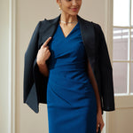 A style comparison of two elegant professional midi dresses with short cap sleeves; the left showcasing a sophisticated teal blue tailored sheath dress with a V-neckline and refined side ruching, and the right featuring the same slimming draping design in a soft pastel lavender lilac color