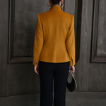 A chic professional Asian woman wearing a luxurious camel wool tailored jacket featuring a sleek stand collar, exposed two-way front zipper, structured shoulders, and an hourglass silhouette paired with a matching skirt.