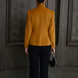 A chic professional Asian woman wearing a luxurious camel wool tailored jacket featuring a sleek stand collar, exposed two-way front zipper, structured shoulders, and an hourglass silhouette paired with a matching skirt.