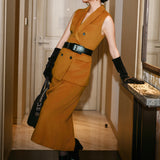 An elegant Asian woman posing in a luxurious camel wool two-piece suit featuring a sleeveless double-breasted longline vest cinched with a wide black belt, paired with a matching midi column skirt and black opera gloves.