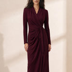 A style comparison of two elegant women's long-sleeve V-neck wrap maxi dresses featuring a flattering side-tie waist and cascading draped ruching; shown on the left in soft oatmeal greige and on the right in rich burgundy wine.