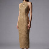 A stunning professional model wearing a luxurious gold sequined halter neck evening gown, featuring a sophisticated keyhole neckline and a slim-fit silhouette for a formal gala look.