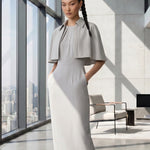 A style comparison of two elegant tailored office sheath midi dresses; the left showcasing a structured vibrant purple dress with a collared capelet sleeve design, and the right featuring a minimalist light grey sleeveless dress with subtle pleated neckline and side pockets.